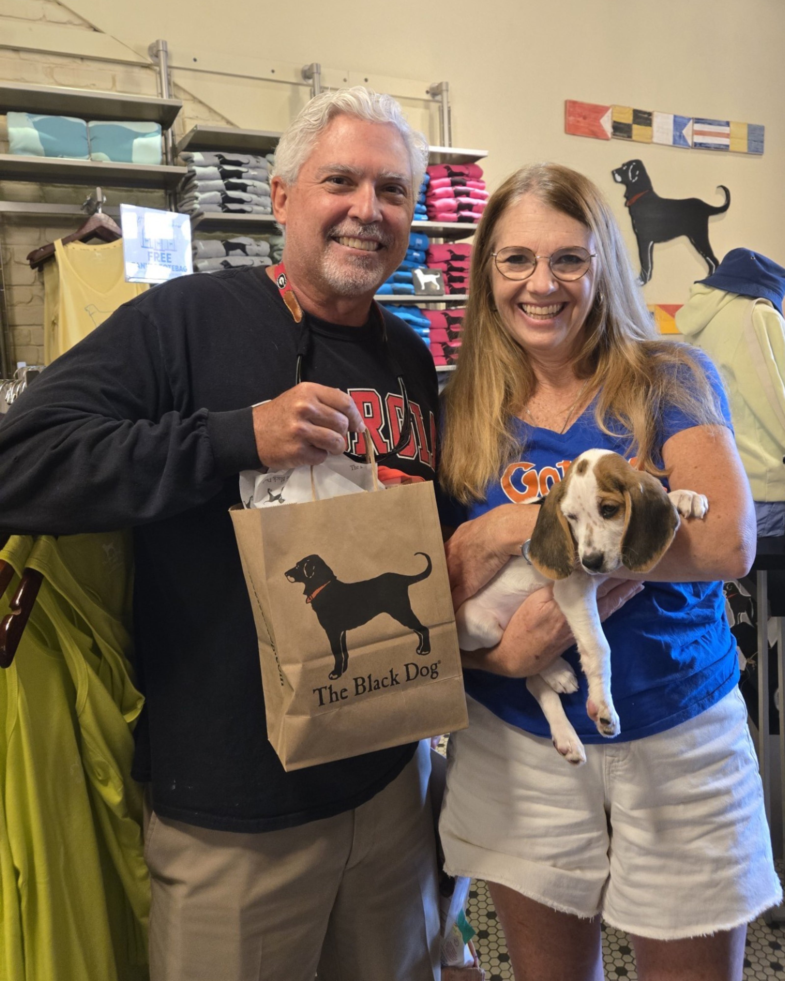 Man holding a tote bag with a dog design
